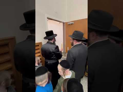 The Ziditchover Rebbe of Chicago lighting the Menorah said to have once belonged to the Bas Ayin