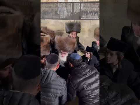 Viznitz Rebbe R Mendel greeting people in his way out from the Kosel