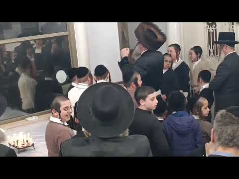 Bitchkov Rebbe Saying Halel With Children Next To His Menorah – Chanukah 5785