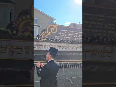 Hasidic Skverer Rebbe, leads the royal Torah caravan through the streets of New York.